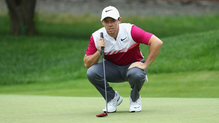 Rory McIlroy of Northern Ireland lines up a putt on the 13th green during the second round of the Travelers Championship