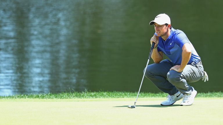 Rory McIlroy of Northern Ireland lines up a putt on the 16th green during the final round of the Travelers Championship