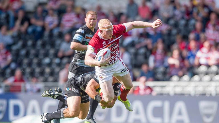 Liam Farrell is tackled by Hull FC's Mark Minichiello