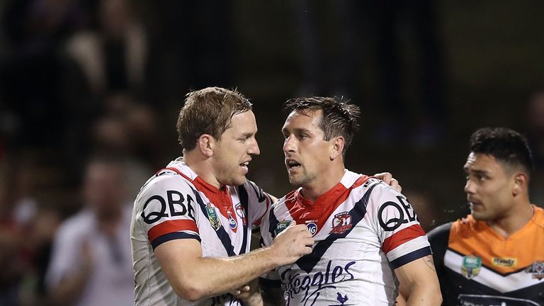 Mitchell Aubusson congratulates Mitchell Pearce after he scored a try against Wests Tigers