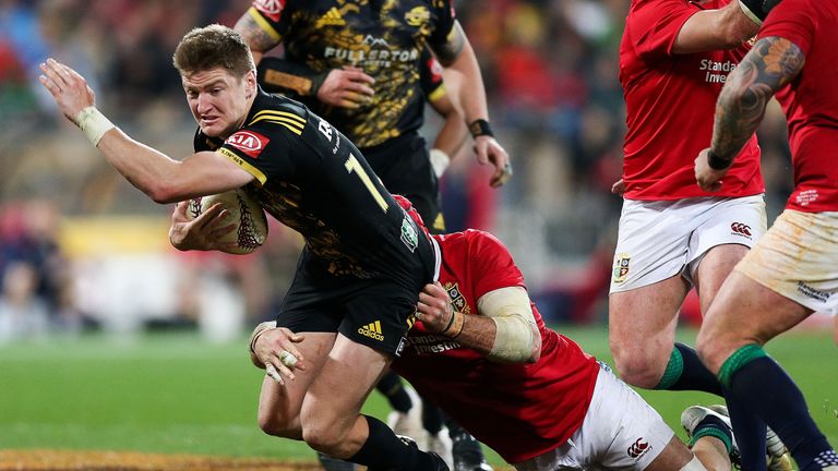 Jordie Barrett of the Hurricanes is tackled by James Haskell during the tour match at Westpac Stadium