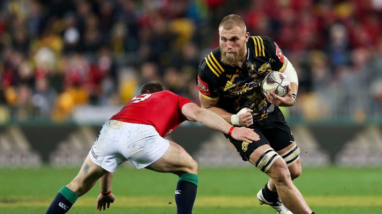 Brad Shields of the Hurricanes is tackled by Greig Laidlaw during the British & Irish Lions tour match at Westpac Stadium