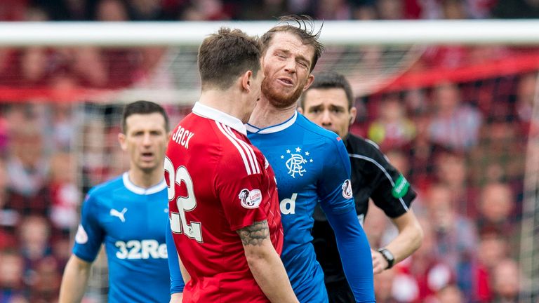 Jack (left) clashes with Joe Garner during the game between Aberdeen and Rangers in April
