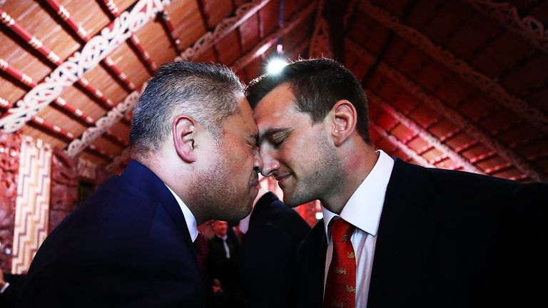 Sam Warburton (R), caption of the British and Irish Lions, receives a "hongi" after being welcomed in the main meeting house during the "British and Irish 