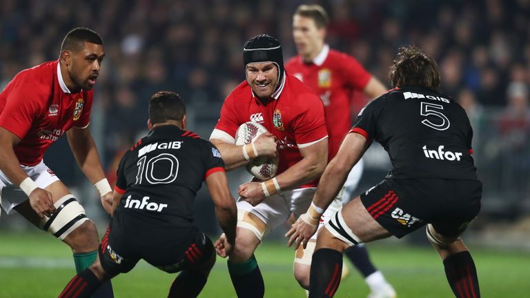 Sean O'Brien of the Lions is tackled by Richie Mo'unga #10 and Sam Whitelock #5 of the Crusaders