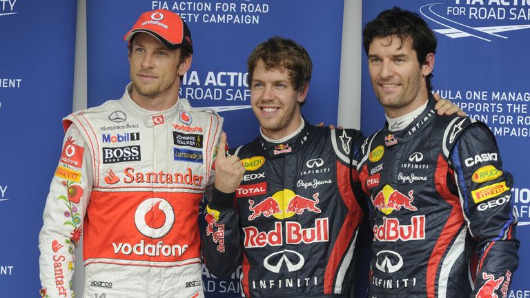 German F-1 driver Sebastian Vettel (C) celebrates his pole position with British Jenson Button of McLaren (L) (second position) and teammate Australian Mar