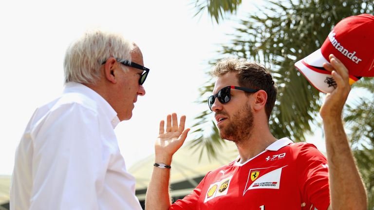 BAHRAIN, BAHRAIN - APRIL 13:  Sebastian Vettel of Germany and Ferrari talks with FIA Race Director, Charlie Whiting in the Paddock during previews to the B