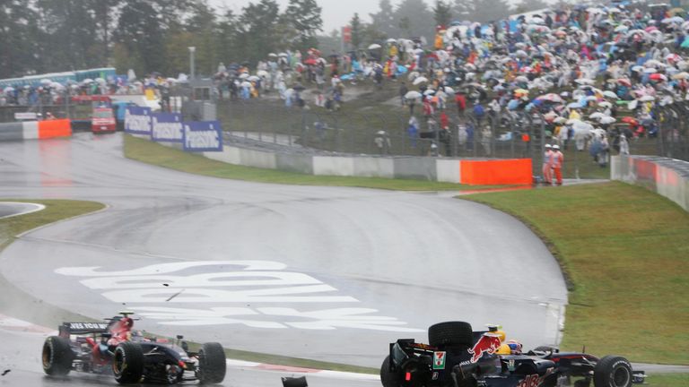 SHIZUOKA, JAPAN - SEPTEMBER 30:  Sebastian Vettel (L) of Germany and Scuderia Toro Rosso collides with Mark Webber (R) of Australia and Red Bull Racing dur