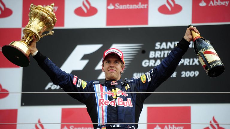 Red Bull's German driver Sebastian Vettel celebrates on the podium of the Silverstone circuit on June 21, 2009 in Silverstone, after the British Formula On