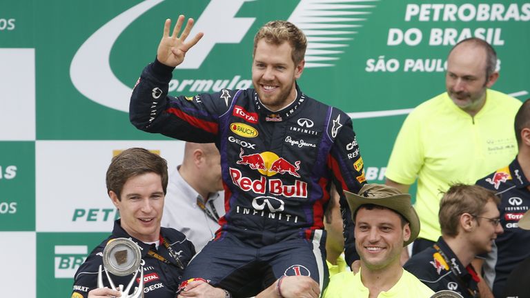 German Formula One driver Sebastian Vettel celebrates his victory in the Brazil F-1 GP on November 24, 2013 at the Interlagos racetrack in Sao Paulo, Brazi