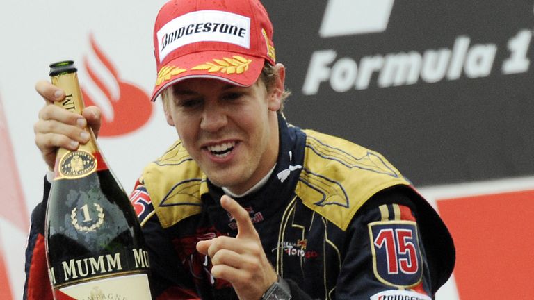 Toro Rosso's German driver Sebastien Vettel celebrates on the podium of the Monza racetrack on September 14, 2008 near Milan, after the Italian Formula One