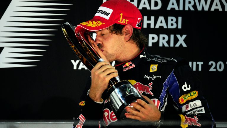 Red Bull's German driver Sebastian Vettel kisses his trophy on the podium of the Yas Marina circuit on November 14, 2010 in Abu Dhabi, after the Abu Dhabi 