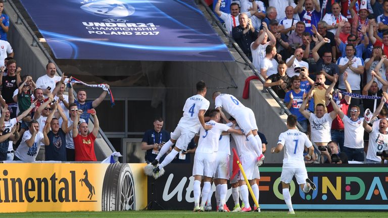 Slovakia's players celebrate scoring the opening goal during the UEFA U-21 European Championship Group A football match Slovakia v England in Kielce, Polan