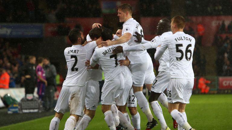 Swansea City's Spanish striker Fernando Llorente celebrates with teammates after scoring their second goal 