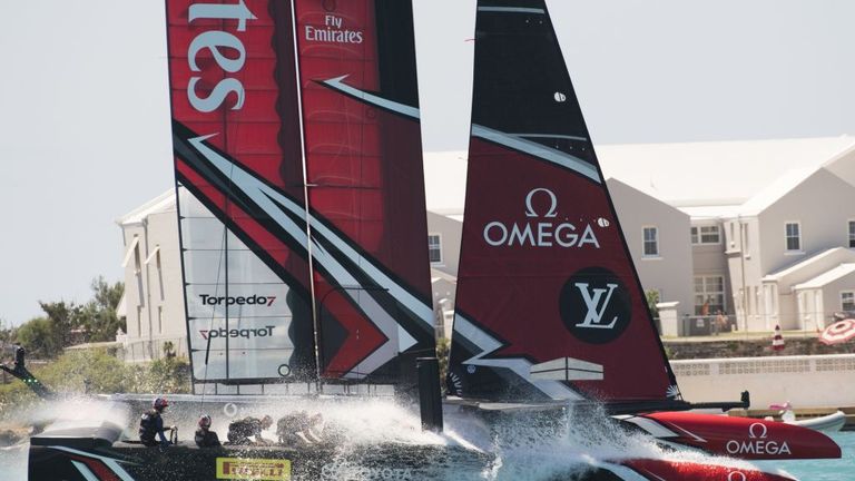 Emirates Team New Zealand splash across finish line to win second race against Oracle Team USA in the Great Sound during the 35th America's Cup