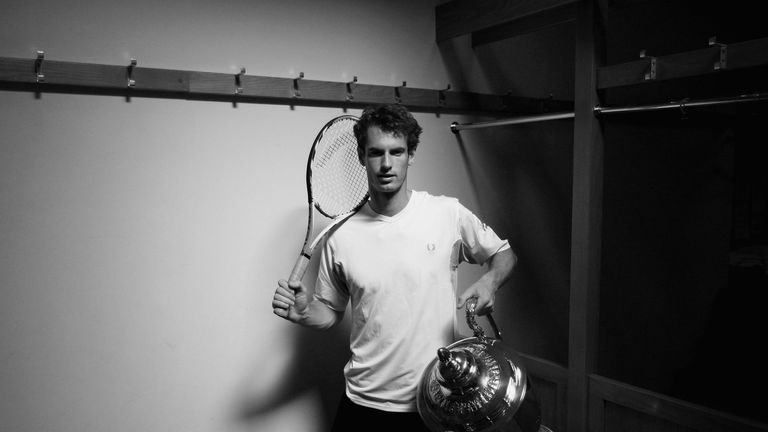 Andy Murray of Great Britain poses in the locker room with the trophy after winning the match and the Championship against James Blake