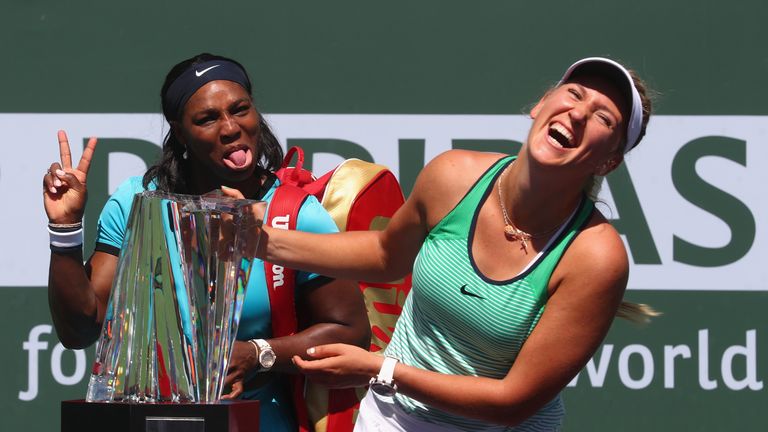 Victoria Azarenka of Belarus laughs with the winners trophy as Serena Williams of USA pulls a face after the final during day