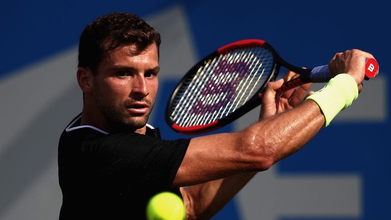 Grigor Dimitrov of Bulgaria plays a backhand during the mens singles second round match against Julien Benneteau of France