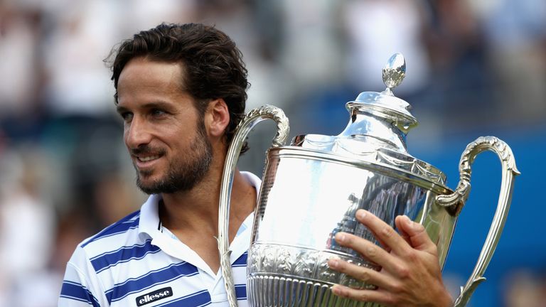 Feliciano Lopez of Spain celebrates with the winners trophy following victory in the mens singles final against Marin Cilic