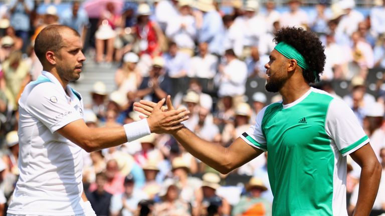 Gilles Muller of Luxembourg shakes hands with Jo-Wilfried Tsonga of France