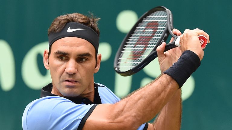 Roger Federer from Switzerland returns a ball to Alexander Zverev (not in picture) from Germany at the final of the Gerry Weber Open