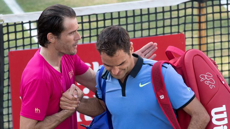 Switzerland's Roger Federer (R) is comforted by Germany's Tommy Haas after he lost at the ATP Cup tennis tournament in Stuttgart