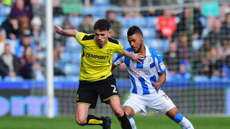 HUDDERSFIELD, ENGLAND - APRIL 01:  Tom Flanagan of Burton Albion holds off  Elias Kachunga of Huddersfield Town during the Sky Bet Championship match betwe