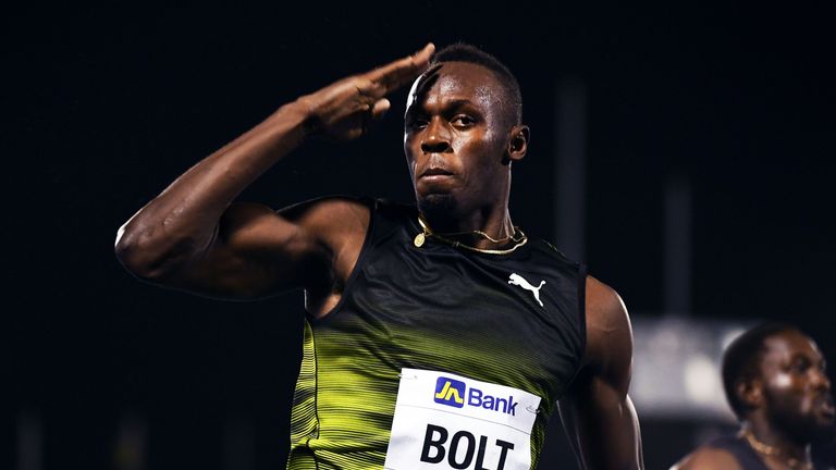 Usain Bolt of Jamaica salutes the crowd as he crosses the finish line of his final race in home country during the Racers Grand Prix at the national stadiu