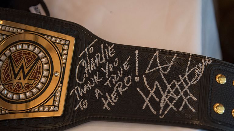 Triple H signed the belt before presenting it