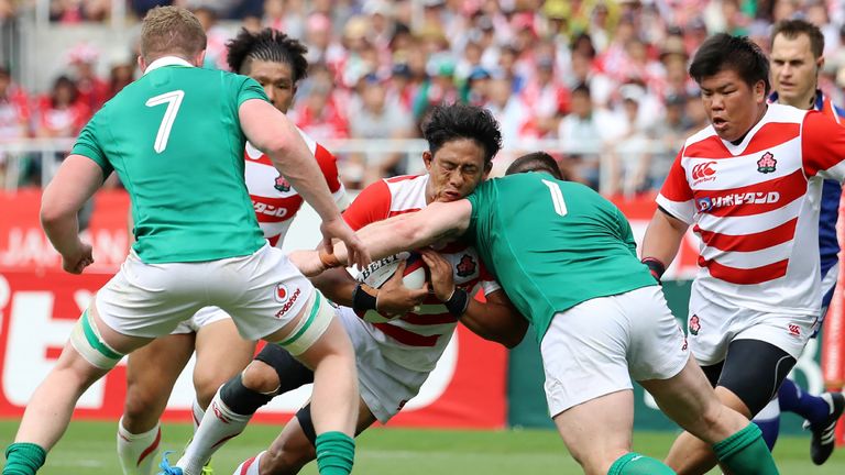 Japan's Yoshitaka Tokunaga (C) is tackled by Ireland's Cian Healy (2nd R) and Dan Leavy (L), as Japan's Heiichiro Ito (R) looks on