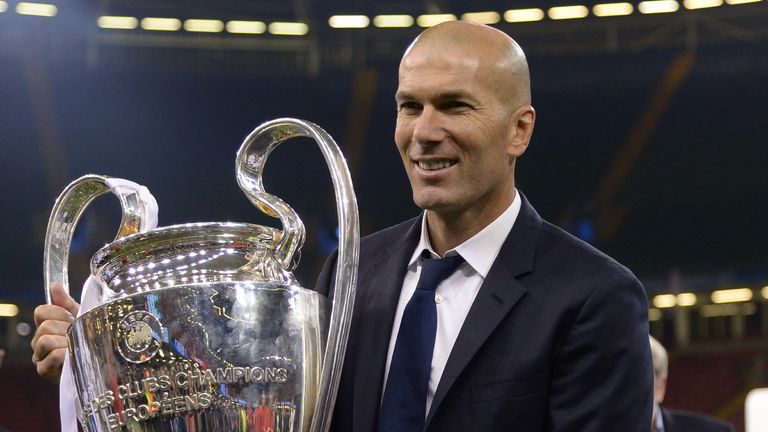 Real Madrid's French coach Zinedine Zidane lifts the trophy after Real Madrid won the UEFA Champions League final football match between Juventus and Real 