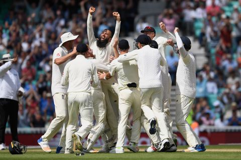 Moeen Ali of England celebrates with team mates after completing his hat trick