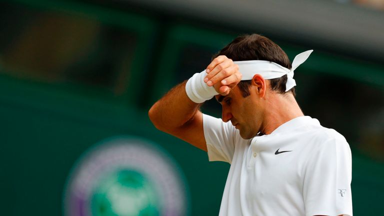 Switzerland's Roger Federer wipes his brow between points against Serbia's Dusan Lajovic during their men's singles second round match on the fourth day of