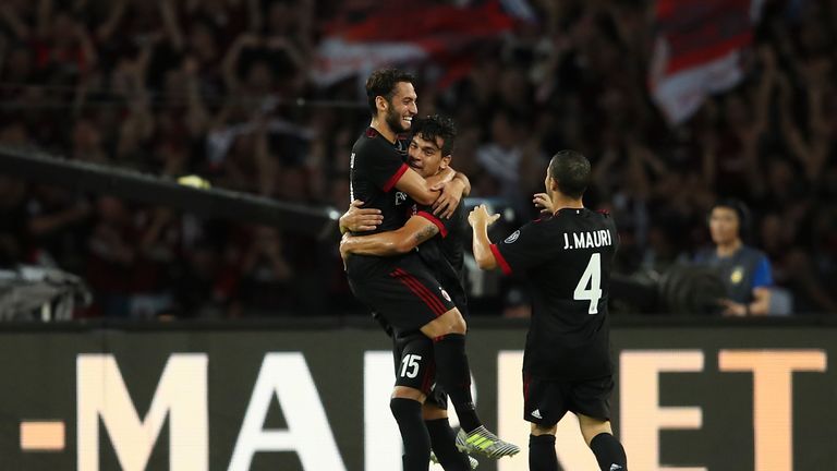 SHENZHEN, CHINA - JULY 22:  Hakan Calhanoglu of AC Milan celebrates a goal with teammate Jose Mauri and Gustavo Gomez during the 2017 International Champio