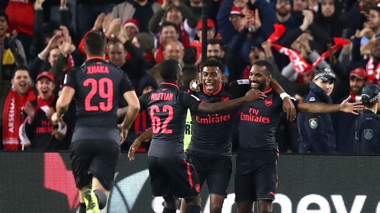 Alexandre Lacazette (far right) is congratulated by team-mates after scoring his first Arsenal goal