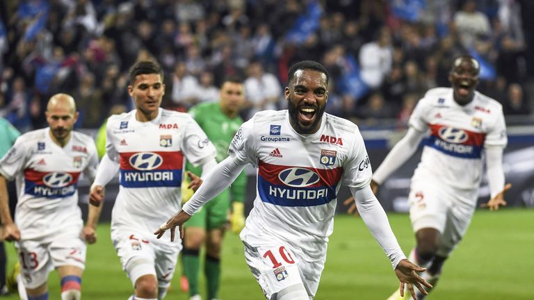 Alexandre Lacazette celebrates after scoring his 100th goal in Ligue 1 during a match between Lyon and OGC Nice