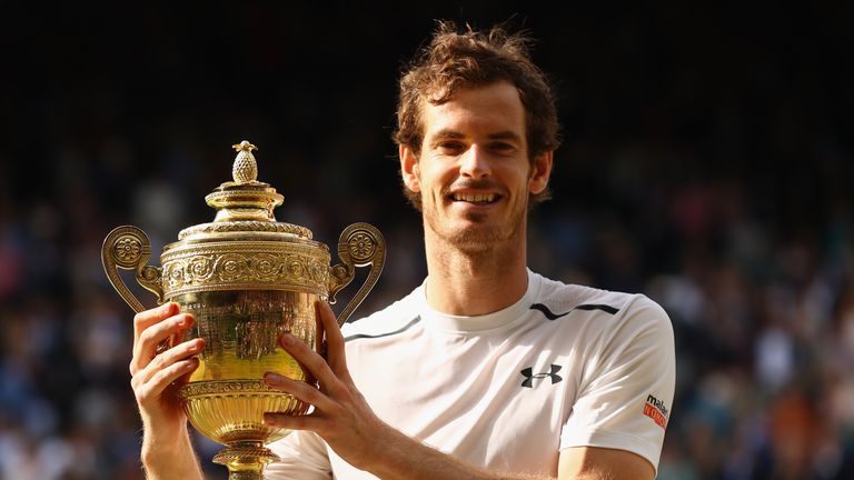 LONDON, ENGLAND - JULY 10:  Andy Murray of Great Britain lifts the trophy following victory in the Men's Singles Final against Milos Raonic of Canada 