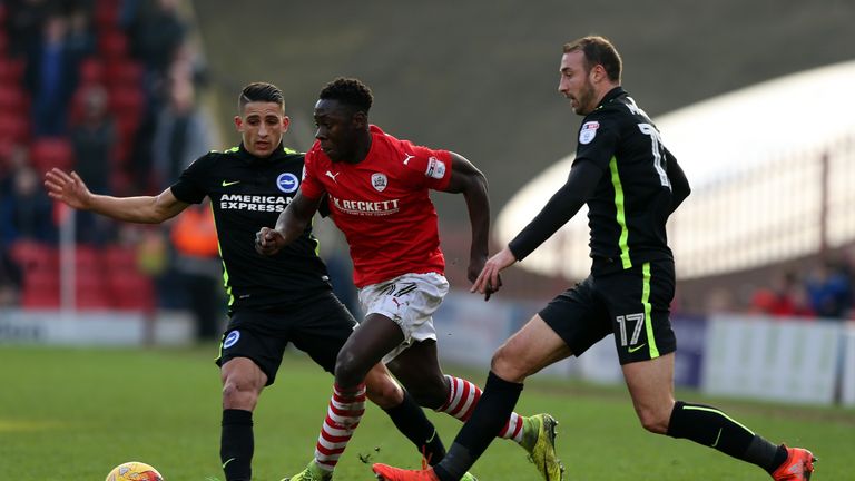 BARNSLEY, ENGLAND - FEBRUARY 18:  Andy Yiadom(C) of Barnsley challenged by Anthony Knockaert (L) and Glenn Murray of Brighton & Hove Albion during the Sky 