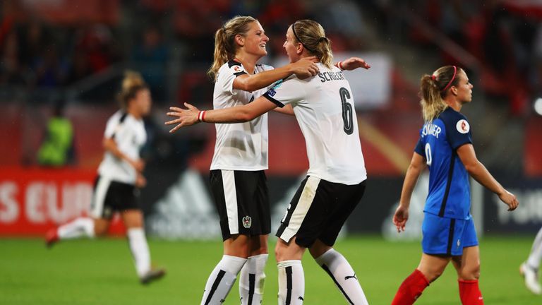 UTRECHT, NETHERLANDS - JULY 22:  Katharina Schiechtl and Carina Wenninger of Austria celebrate the final whistle after the Group C match between France and