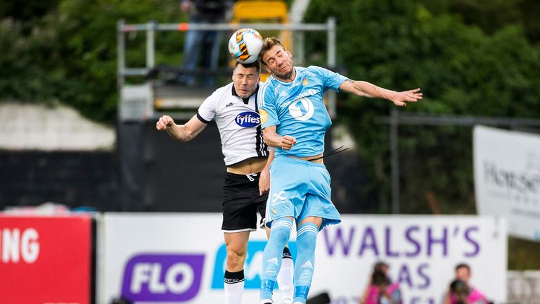 Dundalk captain Brian Gartland (L) battles for possession with Rosenborg's Nicklas Bendtner