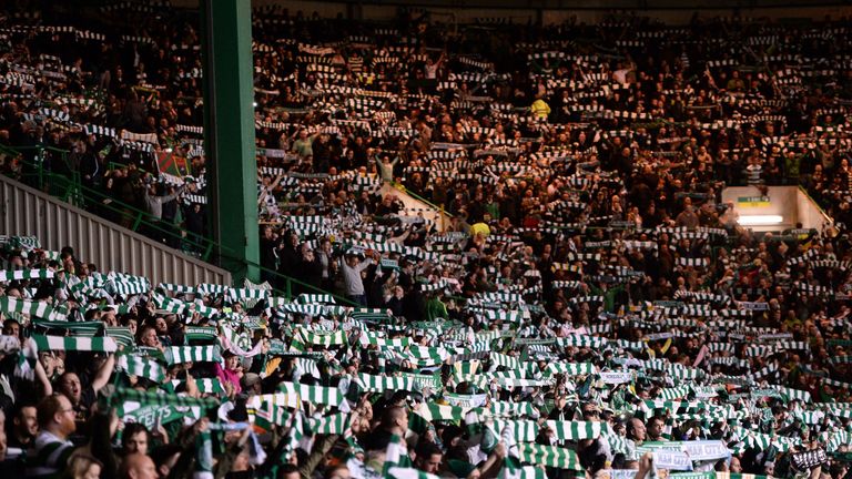 Celtic fans hold aloft scarves ahead of the UEFA Champions League Group C football match between Celtic and Manchester City at Celtic Park