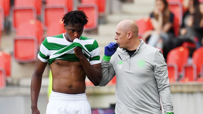 Celtic's Dedryck Boyata goes off the pitch with physio Tim WIlliamson