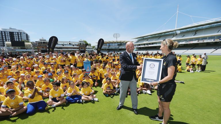 LONDON, ENGLAND - JULY 17:  Official Guinness World Record adjudicator Glenn Pollard presents former England captain Charlotte Edwards with a certificate 