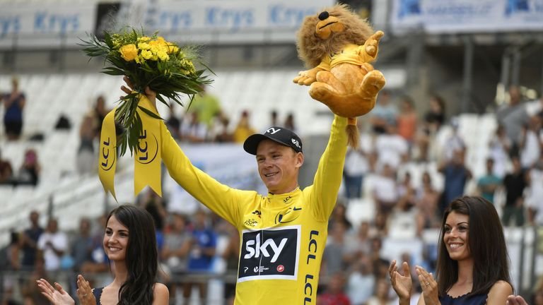 Great Britain's Christopher Froome celebrates his overall leader yellow jersey on the podium at the end of a 22,5 km individual time-trial, the twentieth s