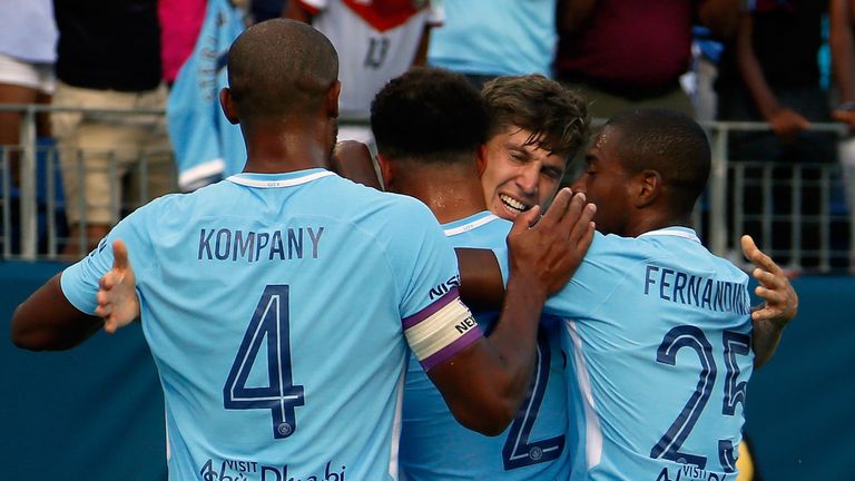 NASHVILLE, TN - JULY 29:  John Stones #5 of Manchester City is congratulated by teamates Vincent Kompany #4 and Fernandinho #25 after scoring a goal agains