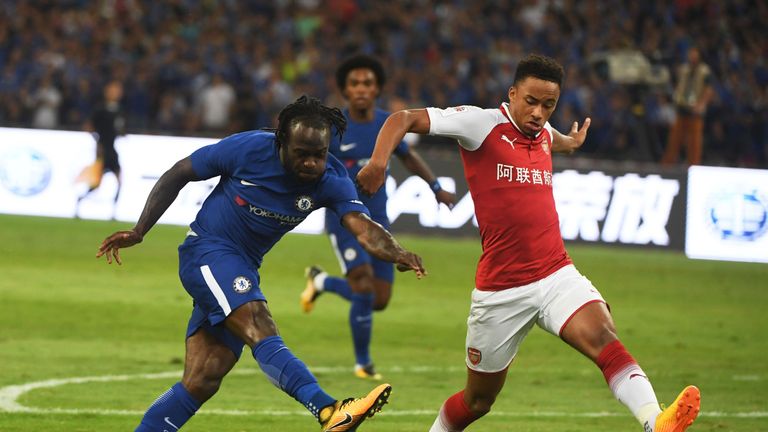 Chelsea's Victor Moses shoots for goal as Arsenal's Cohen Bramall challenges during their friendly football match at Beijing's National Stadium, known as the Bi