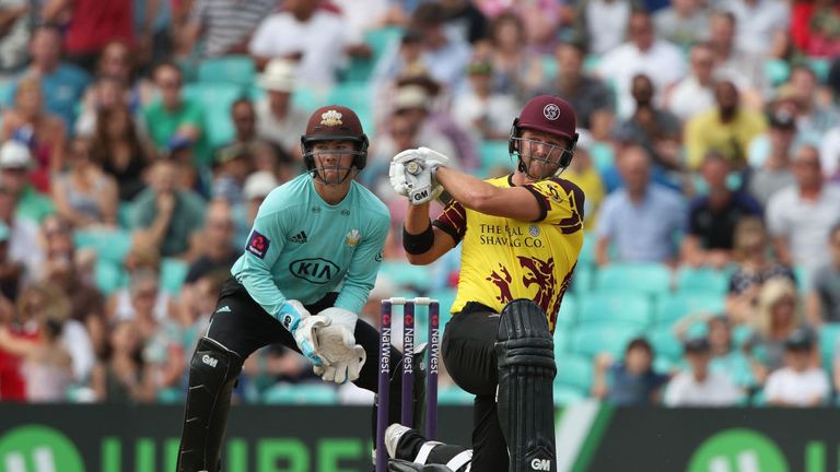 LONDON, ENGLAND - JULY 09: Corey Anderson of Somerset hits a boundary during his innings of 81 as Surrey wicket keeper Rory Burns looks on during the NatWe