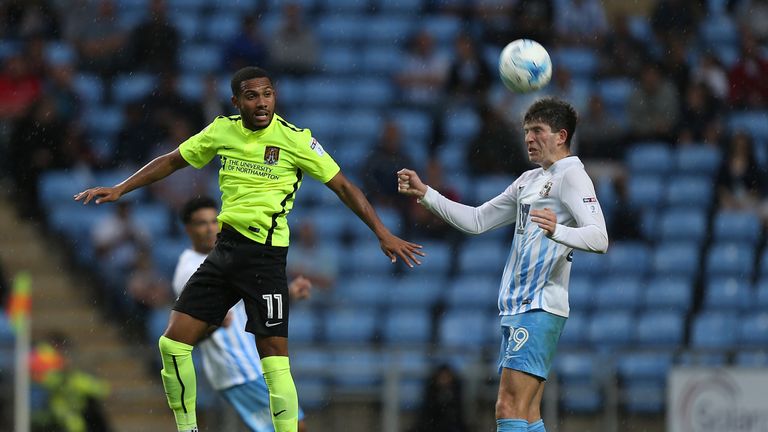COVENTRY, ENGLAND - AUGUST 27:  Kenji Gorre of Northampton Town contests the ball with Cian Harries of Coventry City during the Sky Bet League One match be