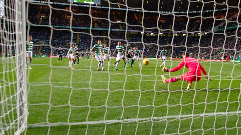 Celtic keeper Craig Gordon (pink jersey) makes a crucial late stop with his left boot