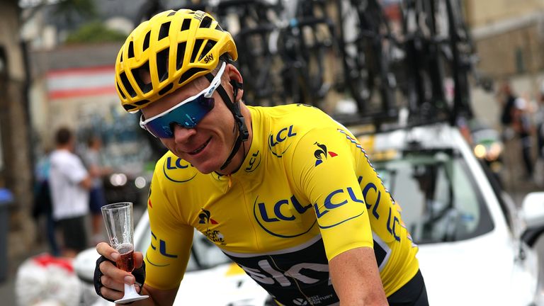 Chris Froome of Great Britain and Team Sky grabs a glass of champagne during stage twenty one of Le Tour de France 2017